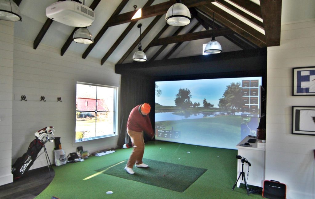 man cave golf house with indoor golf facility