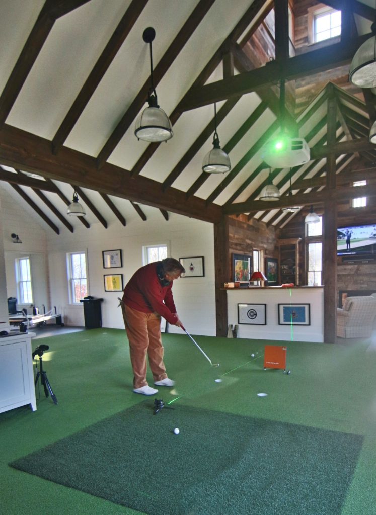 man cave golf house with indoor golf facility