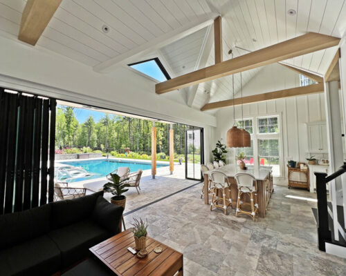 Inviting-farmhouse-kitchen-looking-out-to-pool-in-west-newbury-home