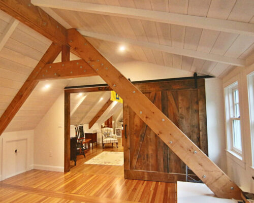attic-office-transformation-with-high-ceiling-and-industrial-beam-detail