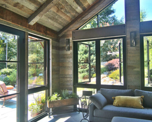 modern-living-space-created-from-small-porch-with-wood-and-steel-accents