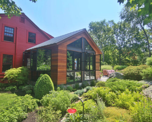 modern-living-space-created-from-small-porch-with-wood-and-steel-accents-landscape